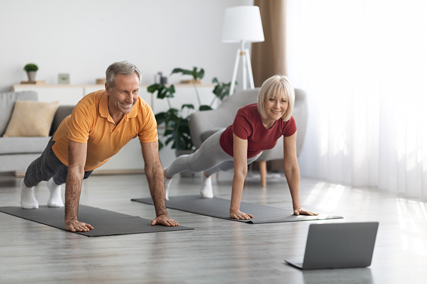 Athletic senior spouses training at home