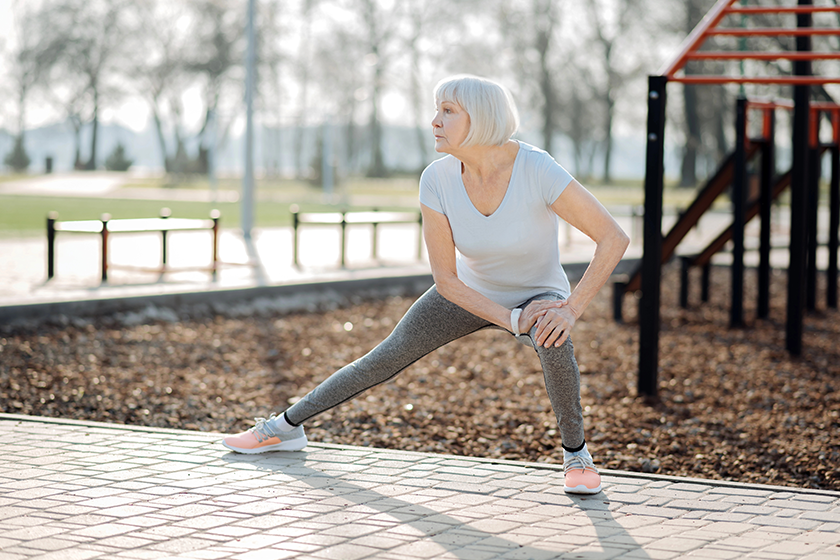 Inspired old woman exercising outdoors